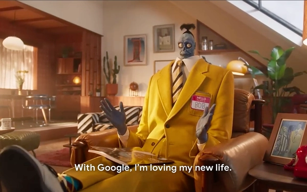 Bob, the Beetlejuice zombie character, sits in a leather chair wearing a yellow suit and Google badge, gesturing.